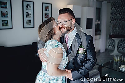 Portrait of a handsome groom with his mother Stock Photo