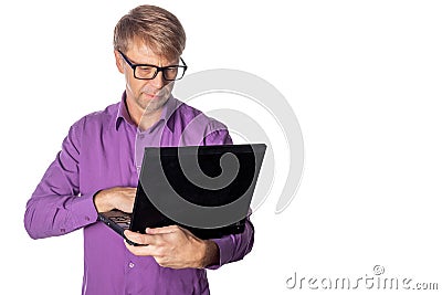 Portrait of handsome guy in casual shirt and glasses using laptop computer. Busy man working Stock Photo