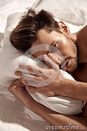 Portrait of a handsome guy resting in the hotel`s apartment Stock Photo