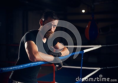 Portrait of handsome kick boxer in the ring at health club Stock Photo