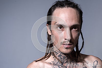 Portrait of handsome man with serious face. Hippie, hipster guy with dread. Stock Photo