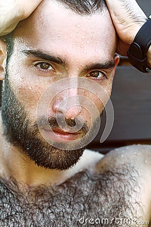 Portrait of handsome masculine guy with drop of water on Ð° fac Stock Photo