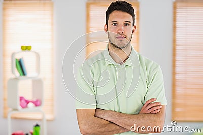 Portrait of handsome masseur with arms crossed Stock Photo