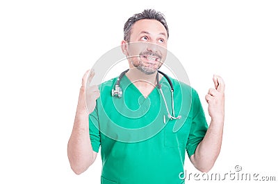 Portrait of handsome medic doing good luck gesture Stock Photo