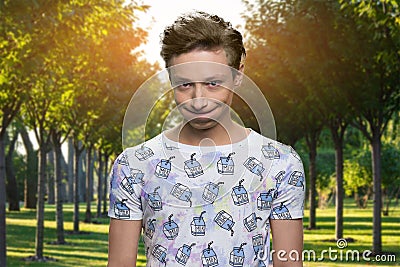 Portrait of handsome offended teen boy in the park. Stock Photo
