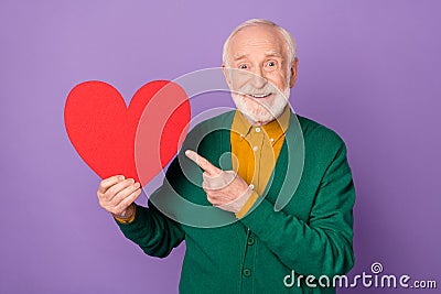 Portrait of handsome person indicate finger large red paper heart postcard isolated on purple color background Stock Photo