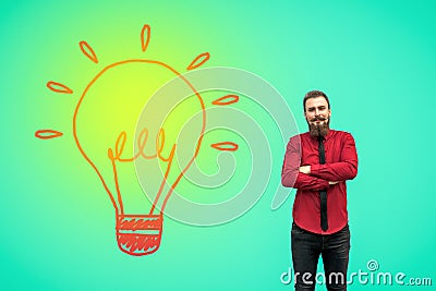 Portrait of handsome satisfied bearded businessman in red shirt standing with raised arms and and looking at camera and smiling Stock Photo