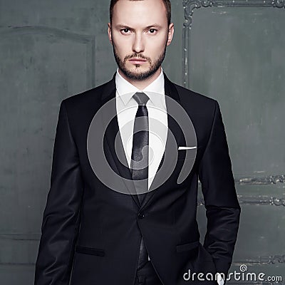 Portrait of handsome stylish man in elegant black suit Stock Photo