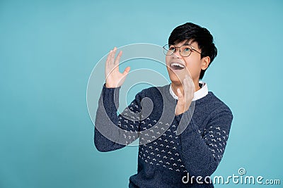 Portrait of a handsome tomboy looking good. Asian woman with short hair wearing casual clothes on light blue background. She was Stock Photo