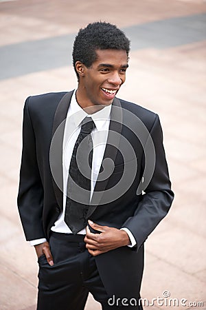 Portrait of a handsome young african american businessman smiling outside Stock Photo