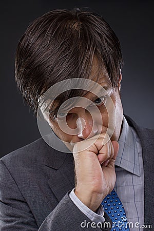 Portrait of handsome young business man thinking Stock Photo