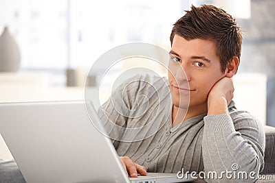 Portrait of handsome young man with computer Stock Photo