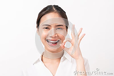 Portrait happily Asian woman shows ok sign and braces smiling witch looking at the camera on white background. Stock Photo