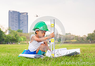 Portrait of happy african american kids boy playing outdoors in a park, Kid playing construction worker concept Stock Photo