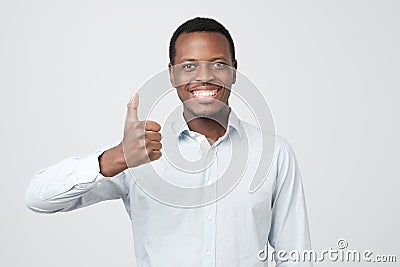 Portrait of happy afroamerican handsome man laughing and showing thumb up Stock Photo