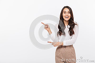 Portrait of a happy asian businesswoman pointing finger away Stock Photo