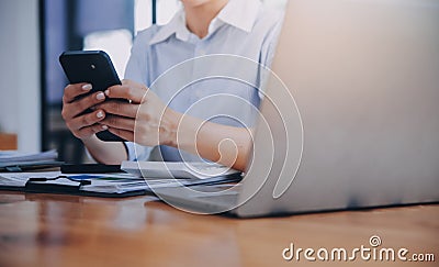 Portrait of a happy Asian businesswoman using mobile phone indoor, Asian businesswoman working in modern office Stock Photo