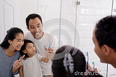 Happy asian family brush their teeth together Stock Photo