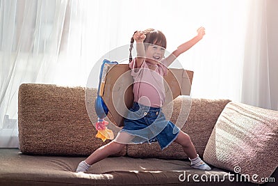 Happy Asian little child girl playing in an astronaut costume Stock Photo