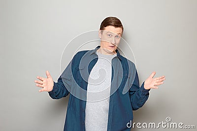 Portrait of happy astonished man raising hands and greeting somebody Stock Photo