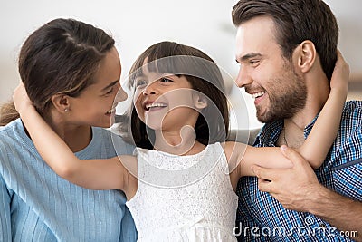 Portrait happy attractive young family posing embracing Stock Photo