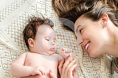 Portrait of happy beautiful mother and cute newborn baby girl Stock Photo