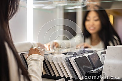 Portrait beautiful woman interior designer chooses finishing materials, countertop, stone samples Stock Photo