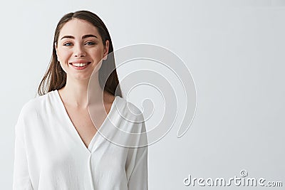 Portrait of happy beautiful young businesswoman smiling looking at camera over white background. Stock Photo