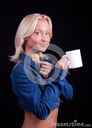 Portrait of happy blonde with cup and cookie Stock Photo