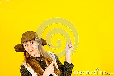 Portrait of a happy brown-haired girl makes a gesture with her fingers, shows an empty space with a surprised expression Stock Photo