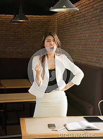 Portrait of happy business woman in coffee shop,Having enjoyed a really impressive success,victory dance, rewarded, won a good con Stock Photo