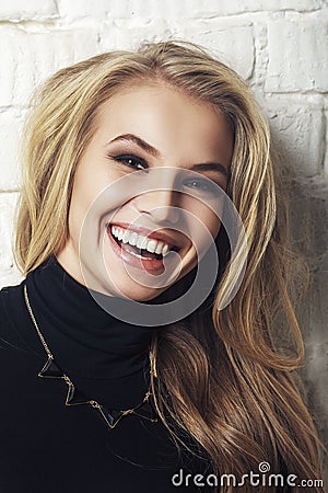 Portrait of happy cheerful smiling young beautiful blond woman Stock Photo