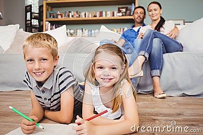 Portrait of happy children coloring on book Stock Photo