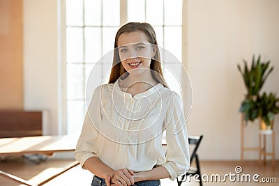 Portrait of happy confident young millennial female businesswoman at office Stock Photo