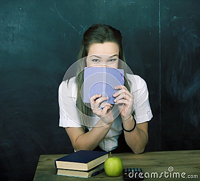 Portrait of happy cute student with book in classroom smiling cheerful, lifestyle people concept Stock Photo