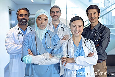 Happy medical team of doctors standing with arm crossed and looking at camera in the hospital Stock Photo