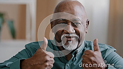 Portrait of happy elderly african american man smiling old senior putting two thumbs up positive grandfather looking at Stock Photo