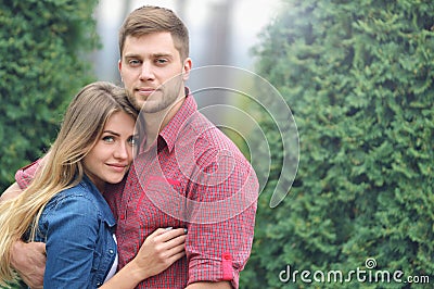 Portrait of happy embracing couple in park Stock Photo