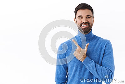 Portrait of happy, enthusiastic male entrepreneur, bearded guy pointing finger left and smiling as inviting check-out Stock Photo