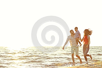 Portrait of happy family and baby enjoying sunset in the summer leisure Stock Photo