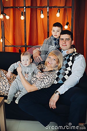 Portrait of happy family embracing in decorated studio. Stock Photo