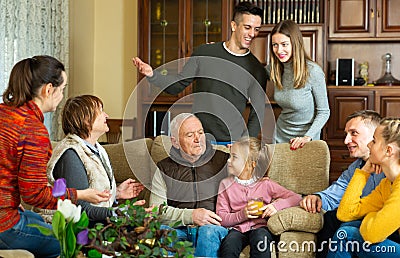 Happy family having conversation together Stock Photo