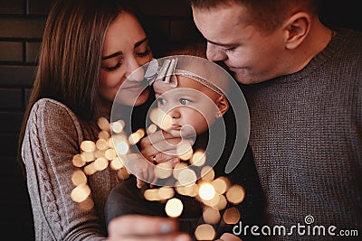 Portrait of happy family, mom, dad and baby girl with sparklers in front. family in anticipation of Christmas Stock Photo