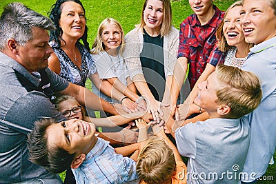 Happy family with nine children heaping hands Stock Photo