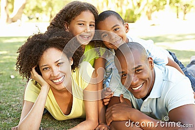 Portrait of Happy Family Piled Up In Park Stock Photo