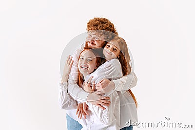 Portrait of happy family, redhaired parents and kid in casual wear look at camera with smile, have good family Stock Photo