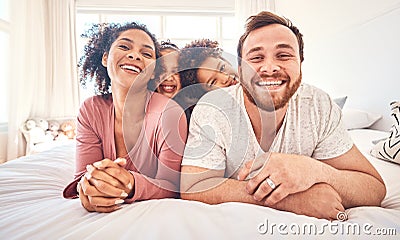 Portrait, happy family and relax on a bed, bond and having fun on the weekend in their home together. Interracial, love Stock Photo