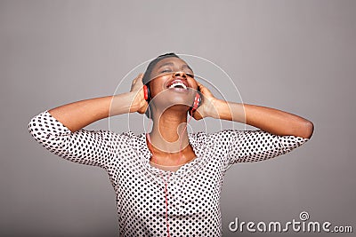 Happy fashionable woman listening to music with eyes closed Stock Photo
