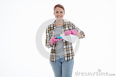 Portrait of happy female doing house duties wearing rubber gloves and holding cleaning equipment. Cheerful look. Hygiene, cleaning Stock Photo