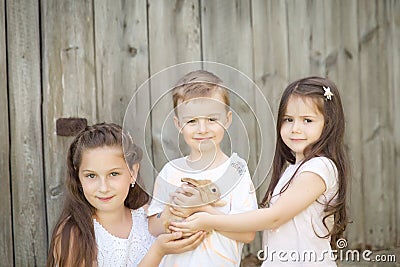 Portrait of happy kids with adorable rabbit Stock Photo